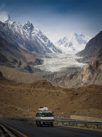 Car on road against snowcapped mountains