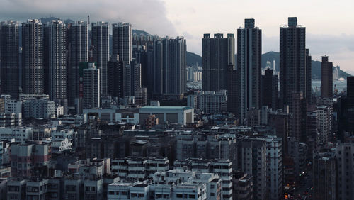 Hong kong modern buildings in city against sky