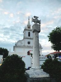 Low angle view of church and building against sky