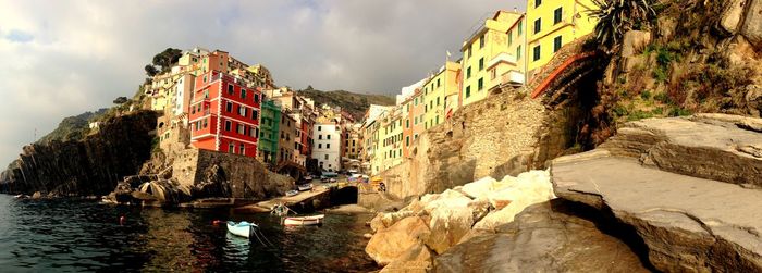 Panoramic view of river amidst buildings against sky