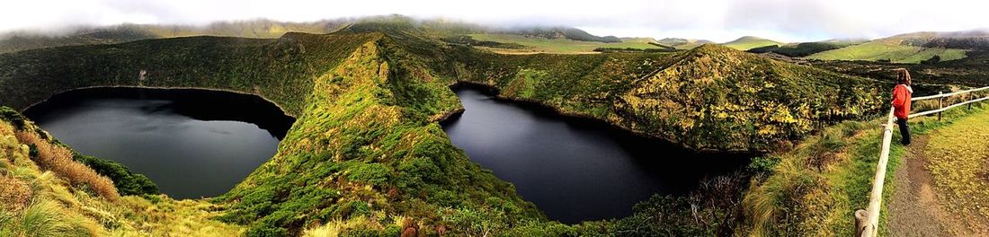 Scenic view of waterfall against sky