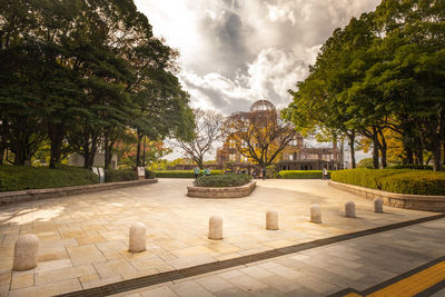 Footpath in park against sky