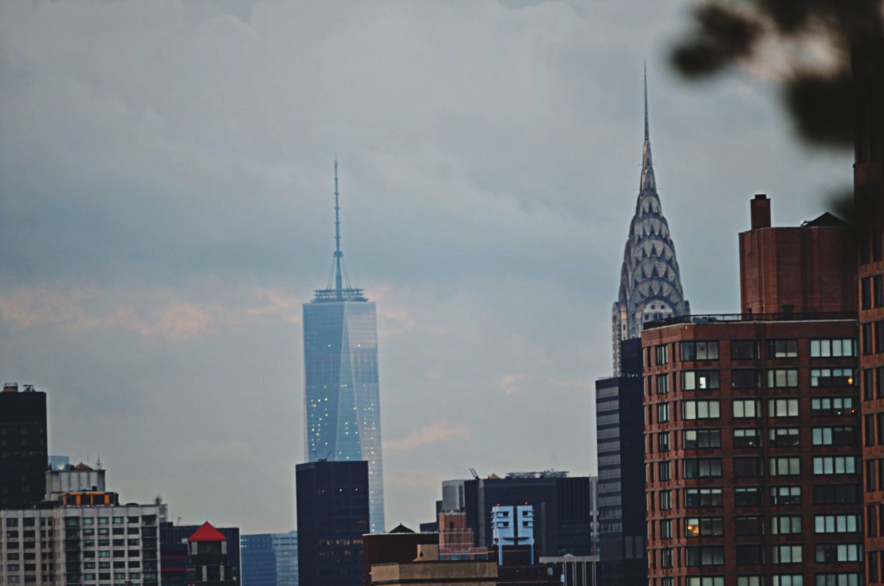 building exterior, architecture, built structure, city, skyscraper, tall - high, tower, modern, office building, sky, low angle view, capital cities, cloud - sky, city life, urban skyline, building, travel destinations, financial district, cityscape, tall