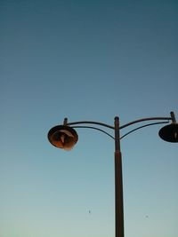 Low angle view of street light against clear blue sky