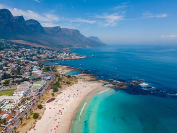 High angle view of sea and mountains against sky