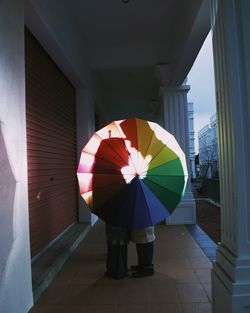 Low angle view of multi colored umbrella in city