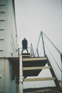 Low angle view of man on built structure