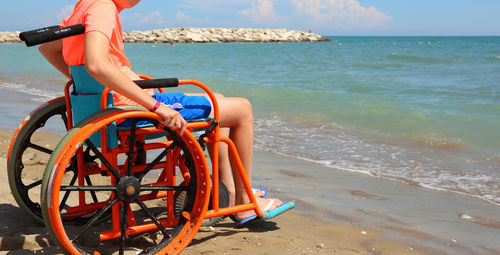 Man on shore at beach against sky