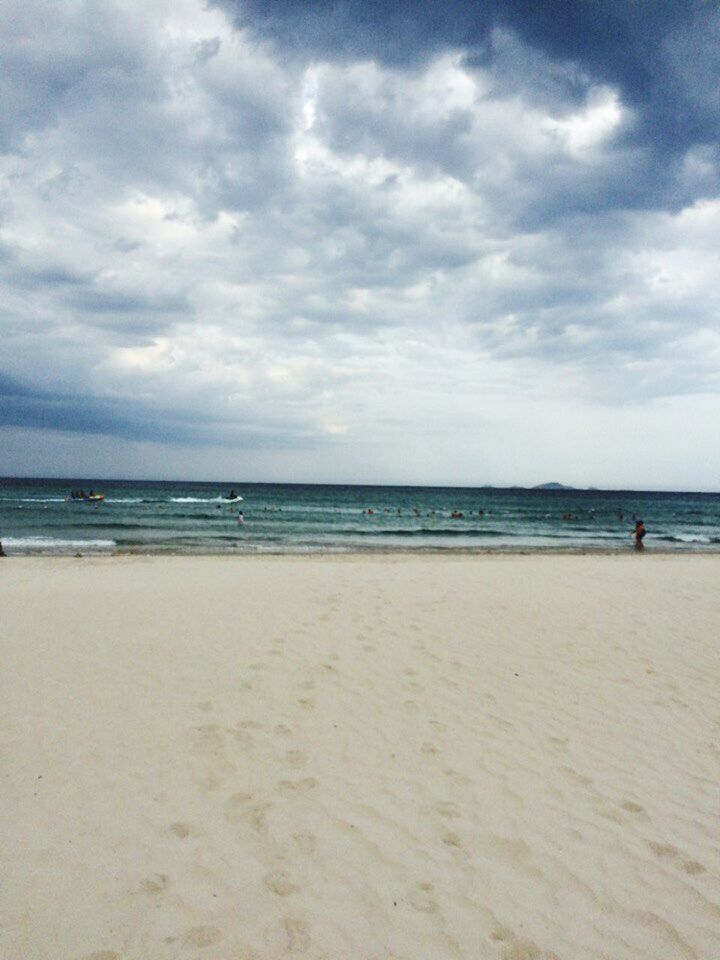 beach, sea, horizon over water, tranquil scene, sand, scenics, water, shore, tranquility, sky, beauty in nature, nature, cloud - sky, calm, coastline, non-urban scene, cloudy, cloud, vacations, day, ocean, blue, outdoors, remote, seascape, tourism, majestic