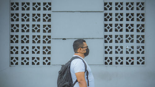 Man standing against wall