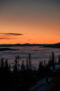 Scenic view of lake against orange sky