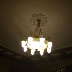 Low angle view of illuminated pendant lights hanging from ceiling