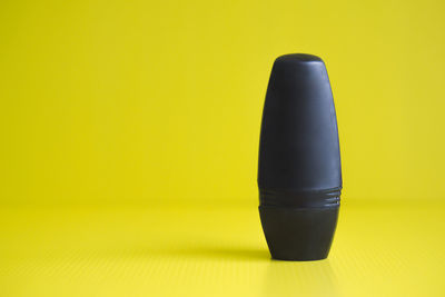 High angle view of black tea on yellow table