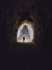 Rear view of man standing in tunnel