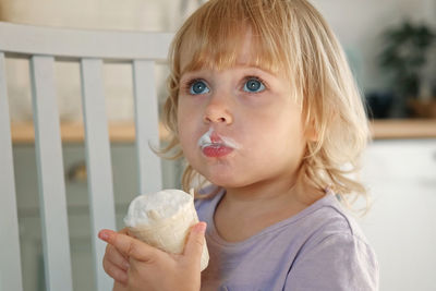 Close-up of cute girl eating food