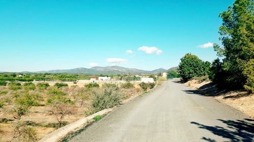 Empty road along countryside landscape