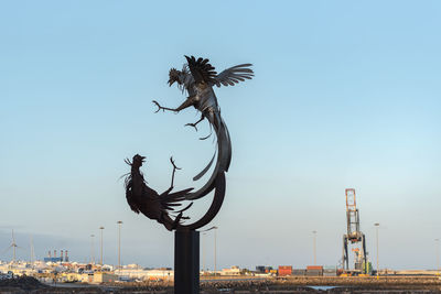 View of bird flying against blue sky