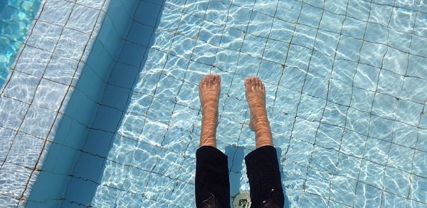 Low section of boy by swimming pool