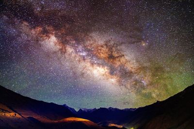 Low angle view of landscape against sky at night