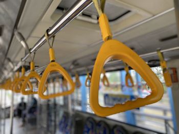 Close-up of hand handles in bus