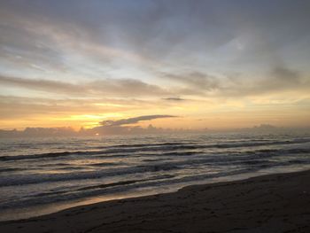 Scenic view of beach against sky during sunset