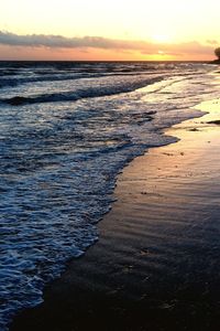 Scenic view of beach against sky during sunset