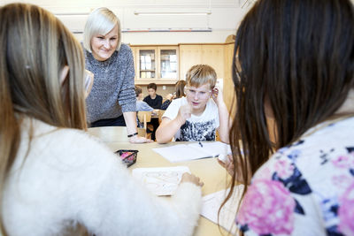 Schoolchildren with teacher in classroom