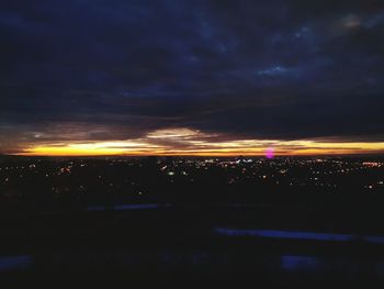 Aerial view of illuminated city against sky at night