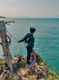 Man on sea against sky