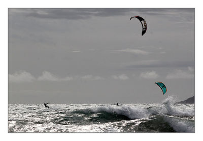 Low angle view of people jumping in sky