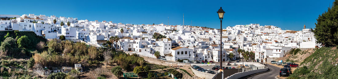 High angle view of town against clear blue sky