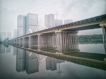 Bridge over river with buildings in background