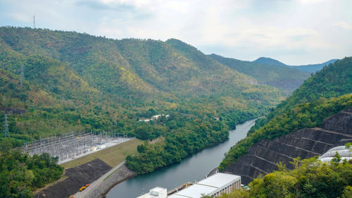 Scenic view of river amidst mountains against sky