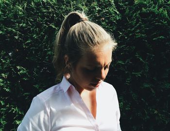 Close-up of woman standing by wall