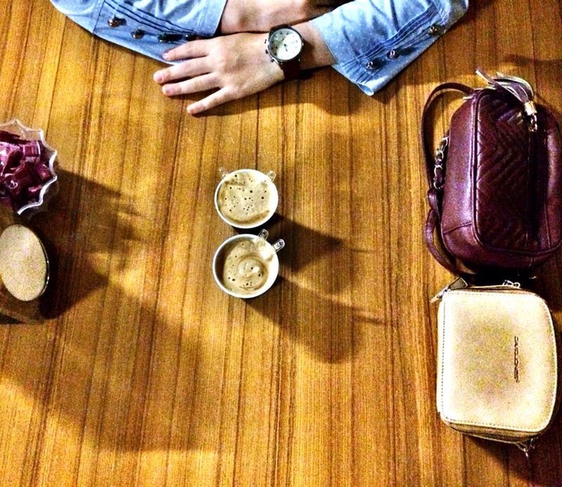 indoors, table, wood - material, high angle view, low section, person, part of, lifestyles, men, food and drink, leisure activity, holding, preparation, directly above, wooden, unrecognizable person