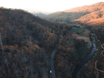 High angle view of road amidst trees against sky