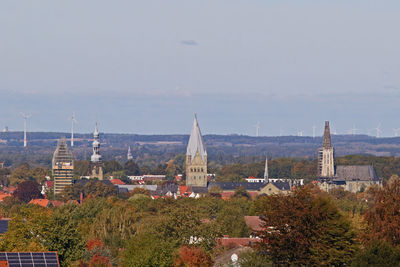 Panoramic view of buildings and trees against sky