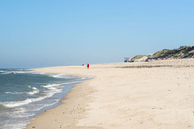 Scenic view of beach against clear sky