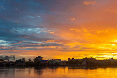 Scenic view of buildings against sky during sunset