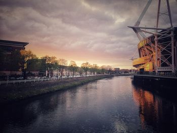 Bridge over river at sunset