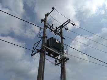 Low angle view of electricity pylon against sky