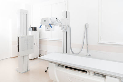 X-ray department in modern hospital. radiology room with scan machine with empty bed.