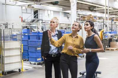 Three women talking in modern factory