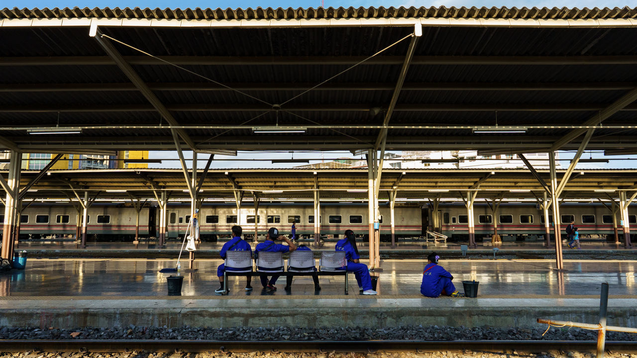 PEOPLE WAITING AT TRAIN STATION