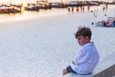Boy sitting on beach