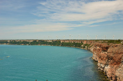 Bridge over sea against blue sky