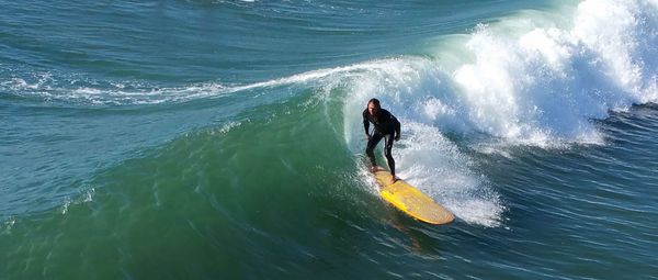 High angle view of man surfing on sea