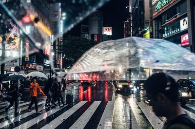 People walking on city street at night