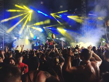 People enjoying music concert at night