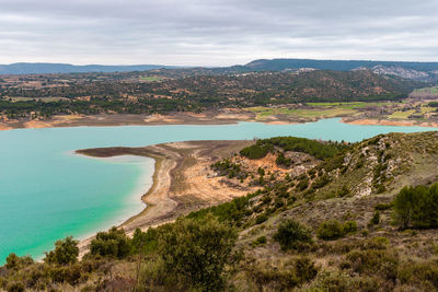 Scenic view of sea and mountains against sky